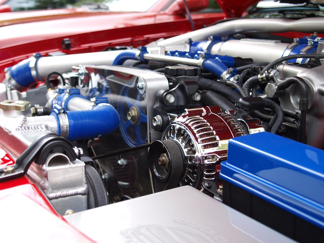 vehicle-chrome-technology-automobile-65623 Detailed view of a clean modern car engine with vibrant colored components and sleek design.